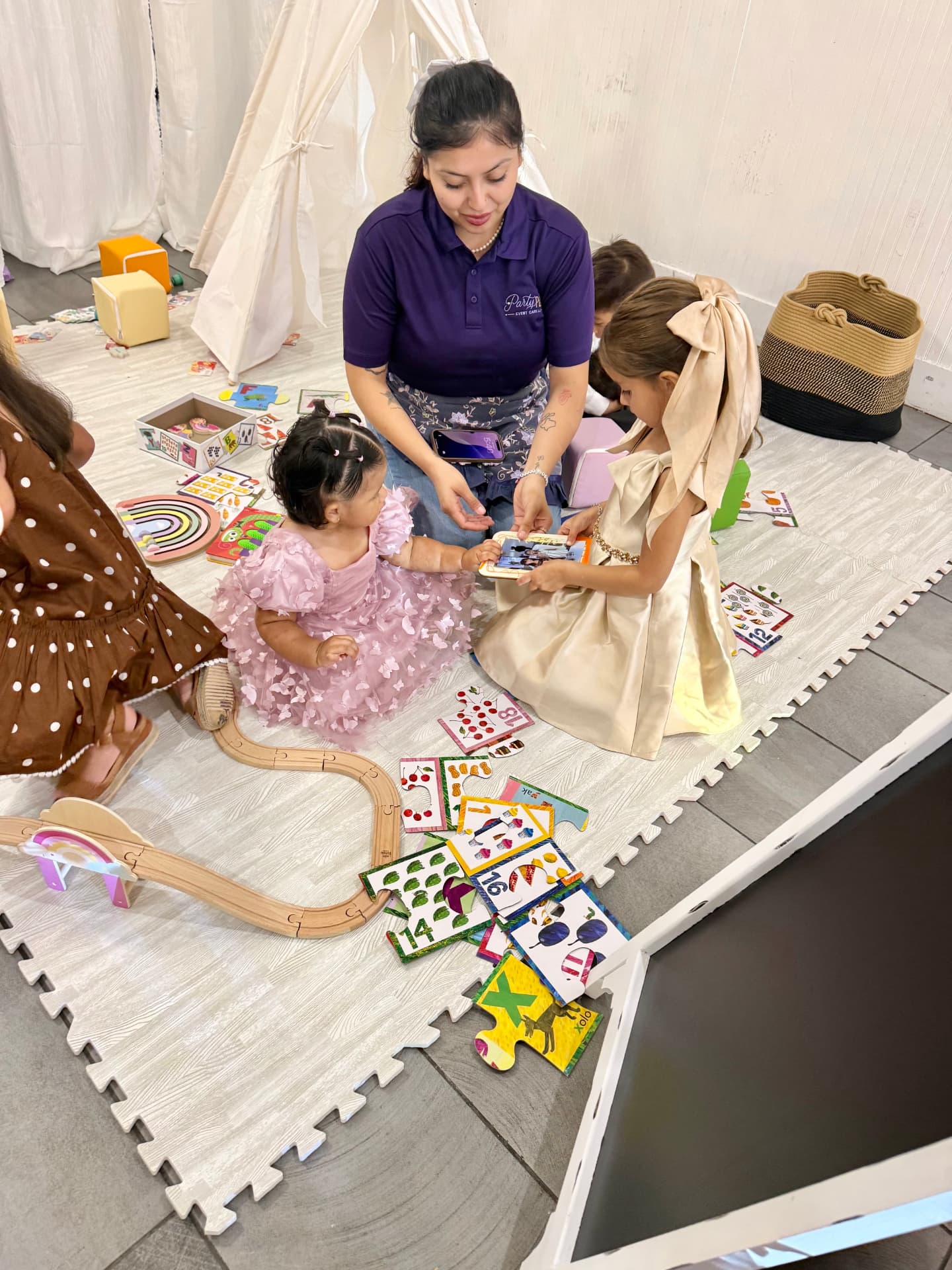 Party Pals caregiver playing puzzles with children at an event